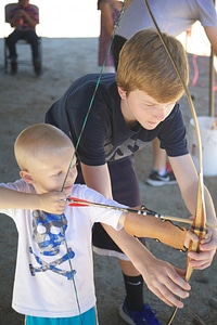 Children shooting bow and arrow photo