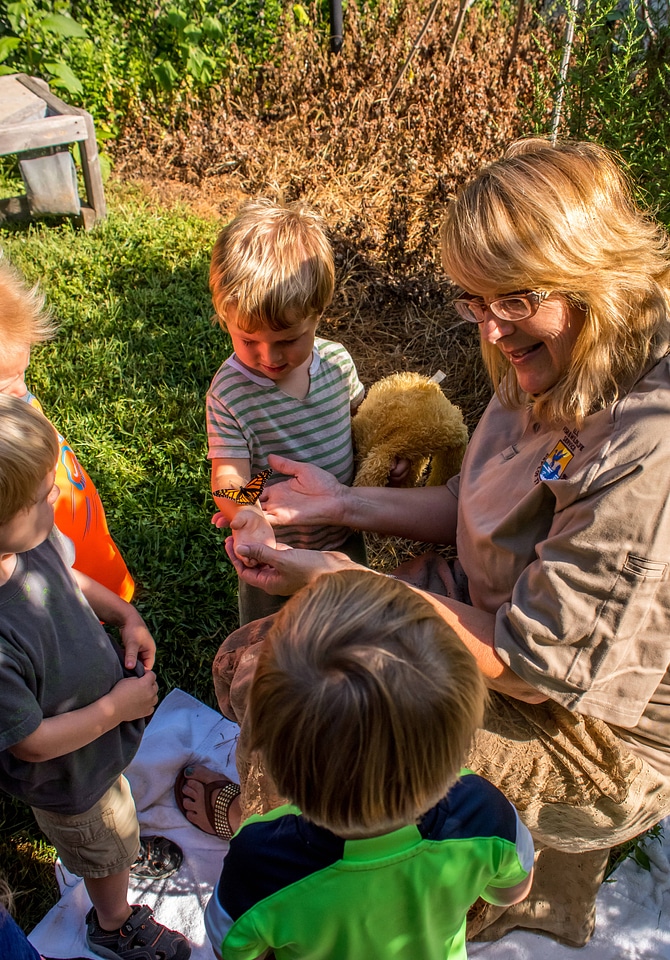 FWS employee showing children a monarch