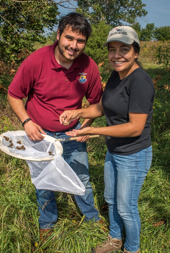 Employee with volunteer and monarch butterfly