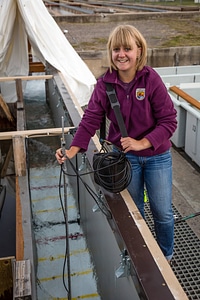 Biologist measures water velocity in a flume-4 photo