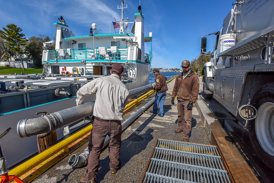FWS staff loading juvenile lake trout onto MV Spencer Baird-1