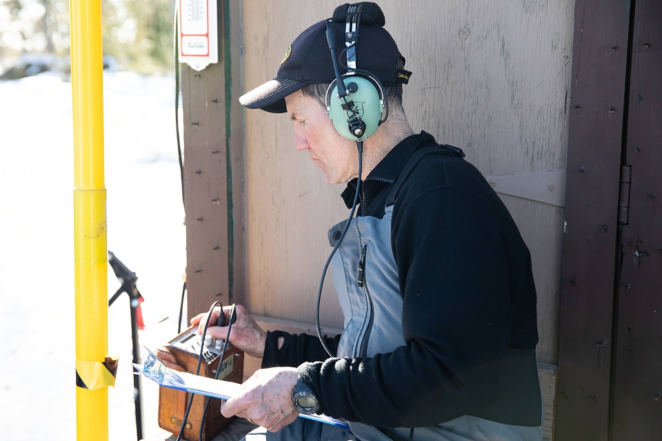 Biologist listens to transmitter used to track lynx
