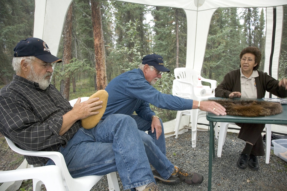 Service employee showing craft to visitors at Tetlin National Wildlife Refuge