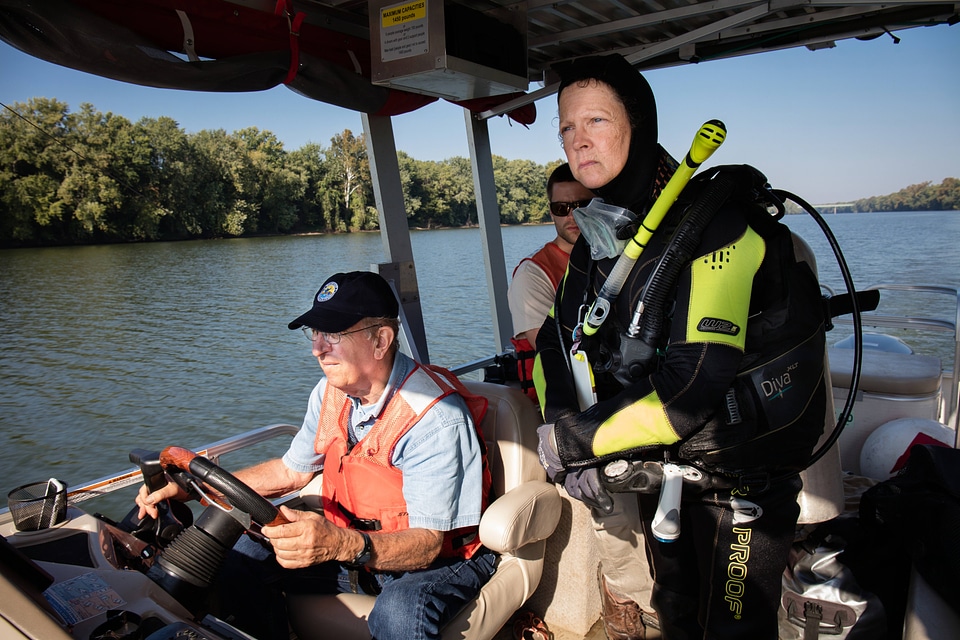 Ohio River Islands biologist, Patricia Morrison, guides a boat on the river