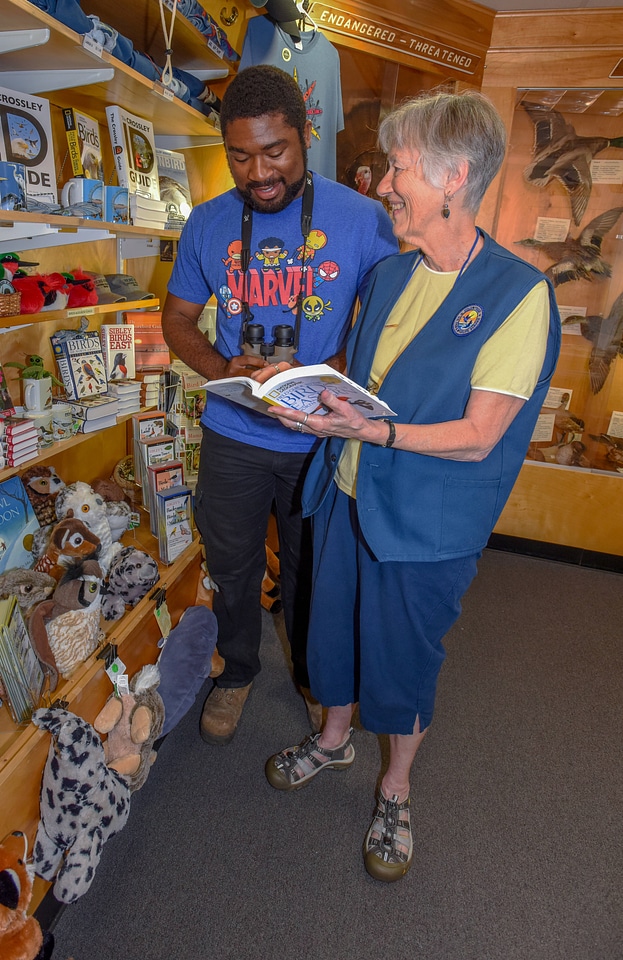 FWS volunteer with visitor in gift shop-3
