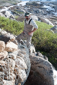 NPS biologist inspects barrier for nonnative trout