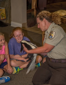 Visitor center program with FWS employee holding skunk-1