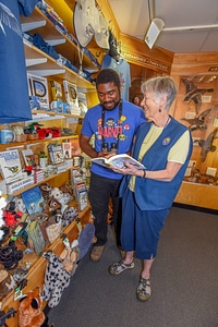 FWS volunteer with visitor in gift shop-2