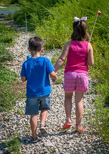 Little boy and girl going fishing, walking along creek-1
