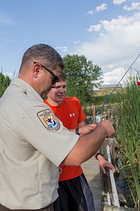 Ranger and young boy fishing-1
