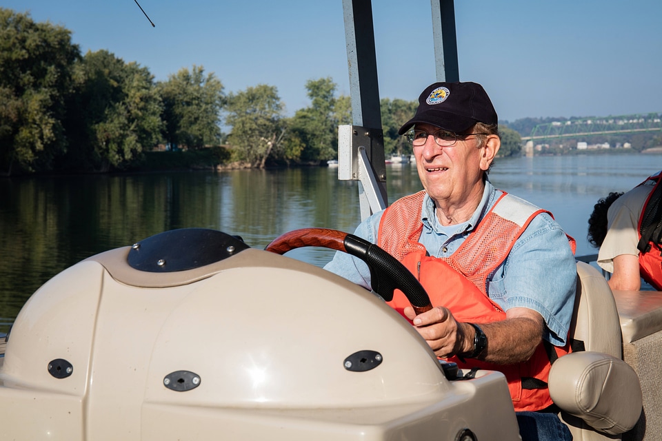 Volunteer, Richard Esker, drives a boat on the Ohio River-4