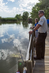 Ranger and young girl fishing