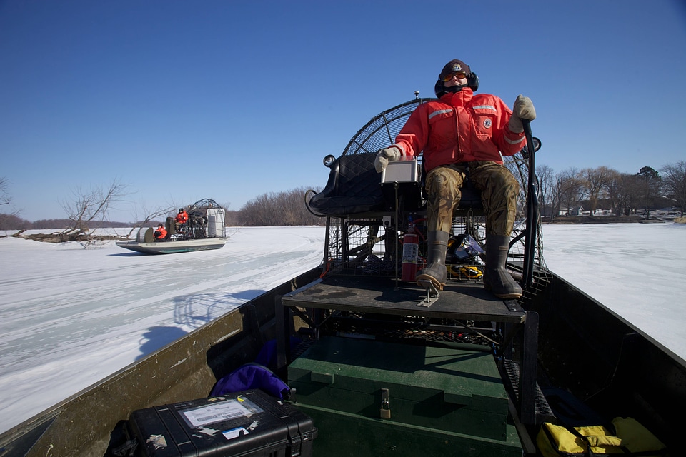 Service employee pilots airboat