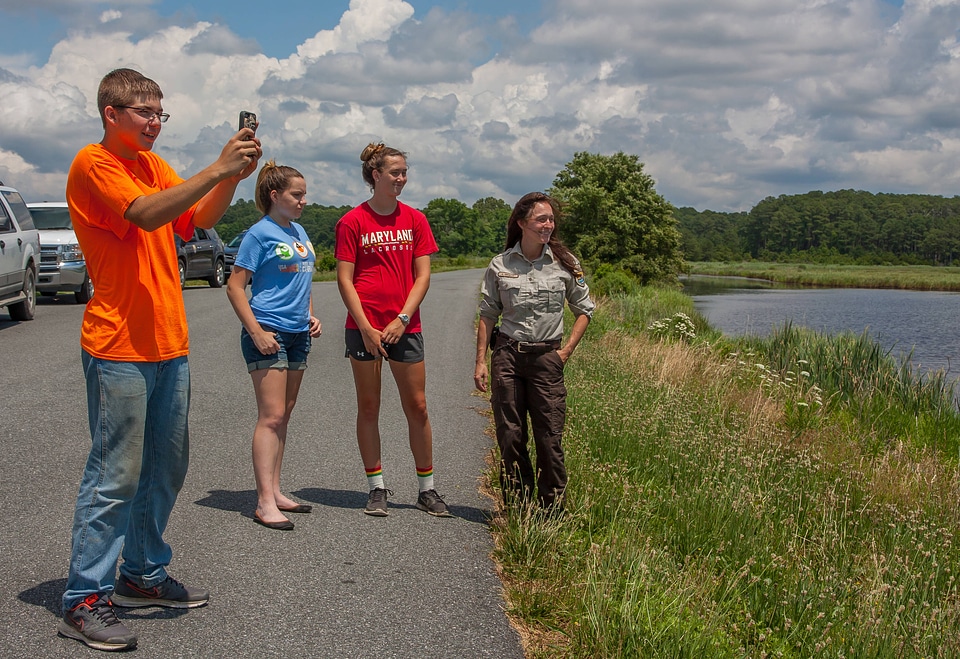 FWS staff with students taking cell phone pictures at wetland-4
