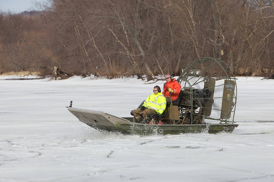 Employees riding on an airboat on the Mississippi River