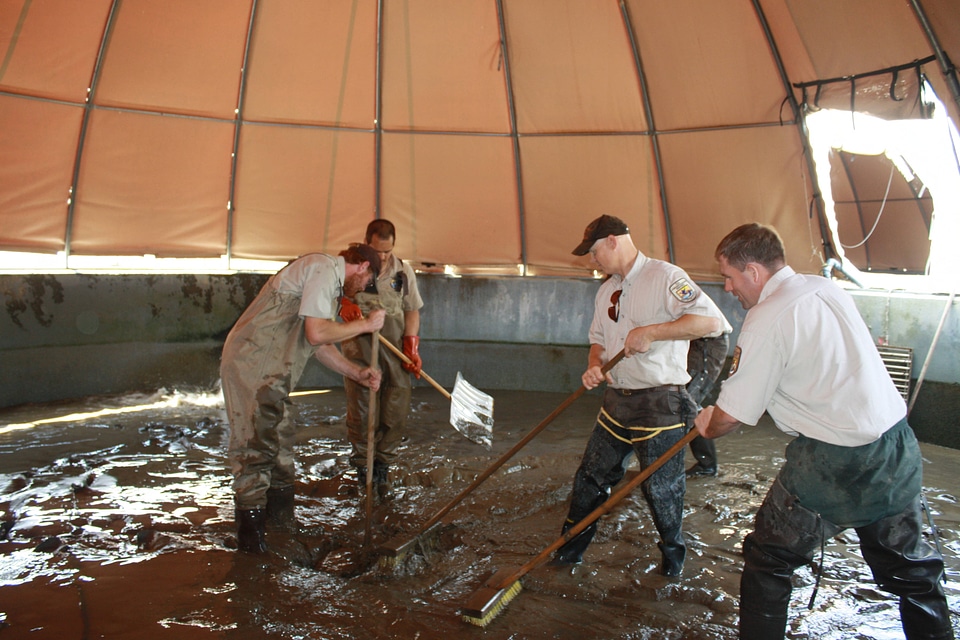 Cleaning river sediment deposited by Hurricane Irene flood waters