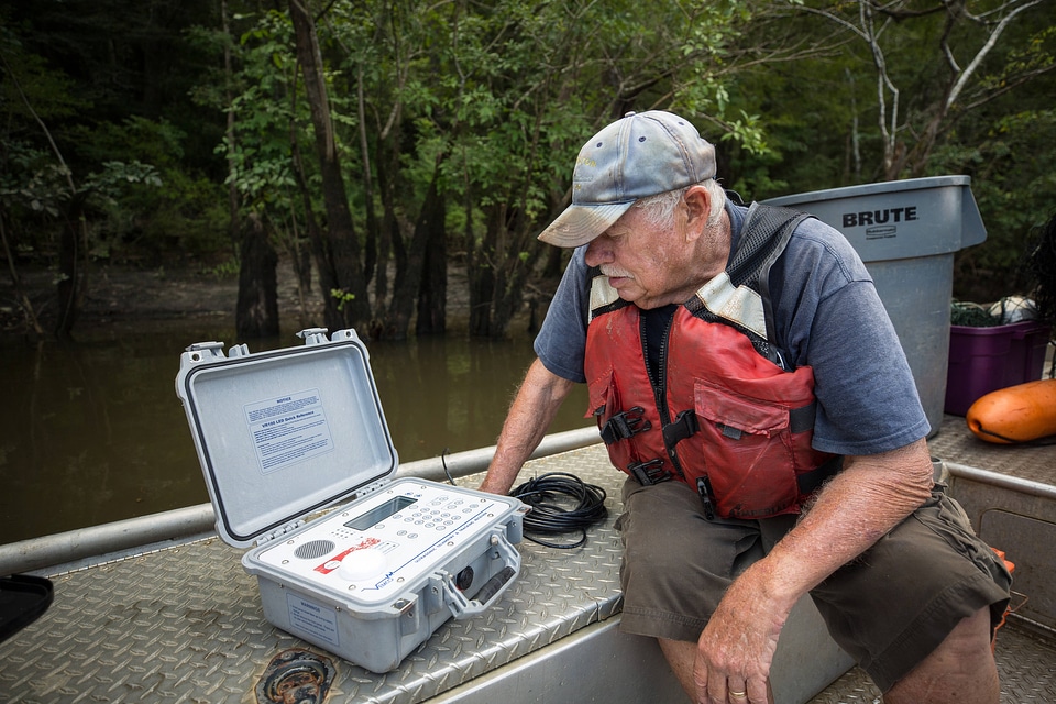Biologist in boat study Gulf sturgeon in river-1