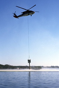 Helicopter dumps oyster shells at restoration site