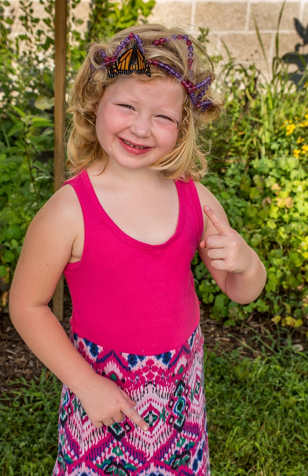 Little girl with monarch in hair