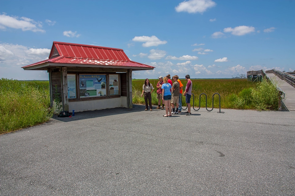 FWS staff talks to group of high school students at kiosk-6