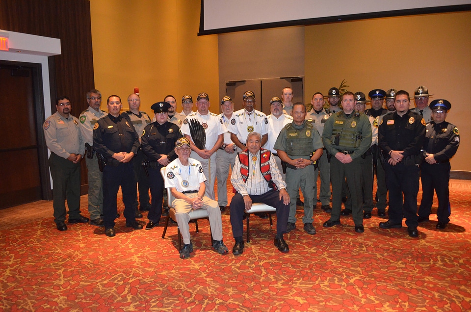 Tribal law enforcement, Conservation Officers and Elders pose for award 