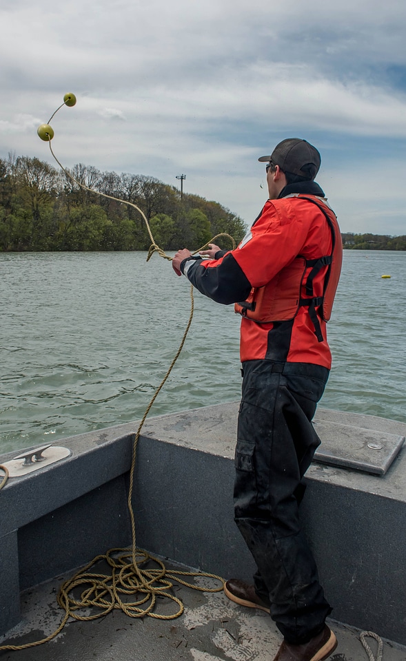 USFWS Fisheries worker thowing out buoys-1