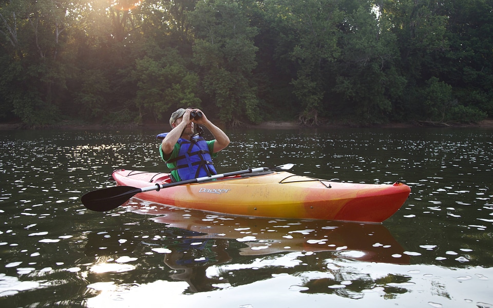 Man looking through binoculars while sitting in a kayak-7 photo