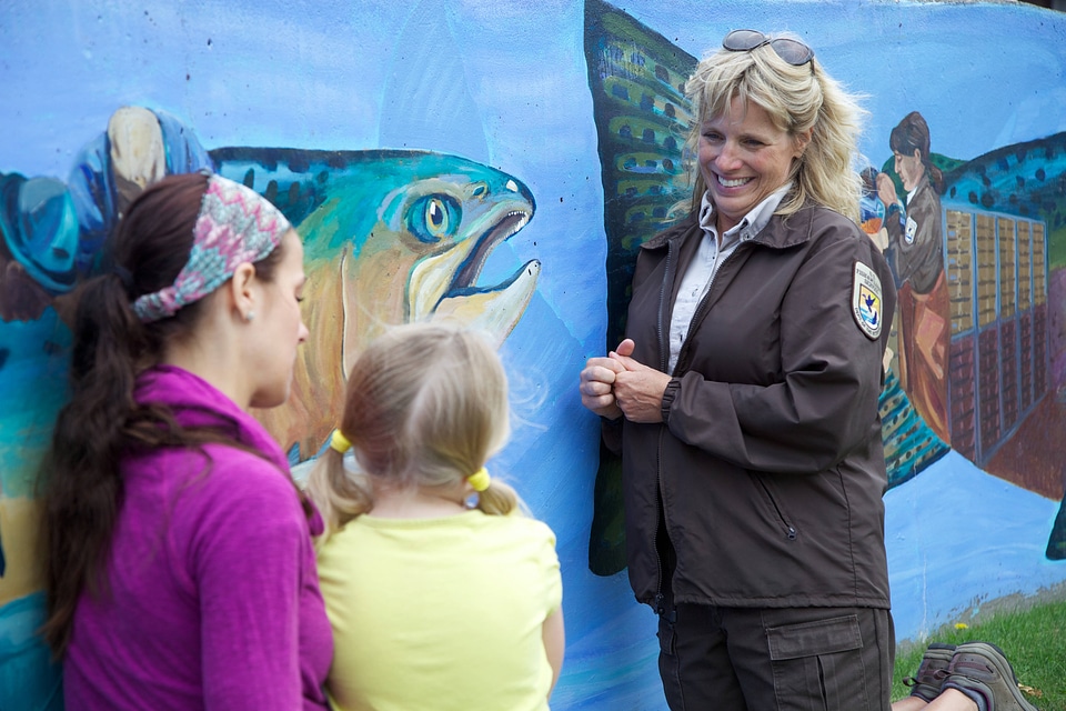 Service employee models environmental education simulation of a Pacific salmon-2