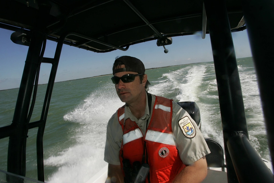 Service employee operates refuge boat