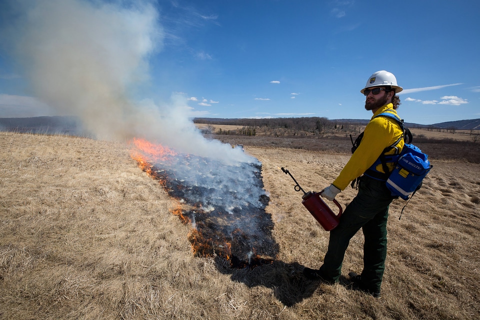Firefighter standing guard over fire