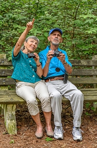 Visitors on bench look at wildlife photo