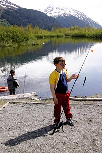 Boy with fishing pole and a small fish