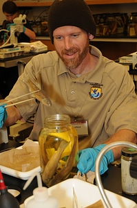 Service employee with jar of specimens photo