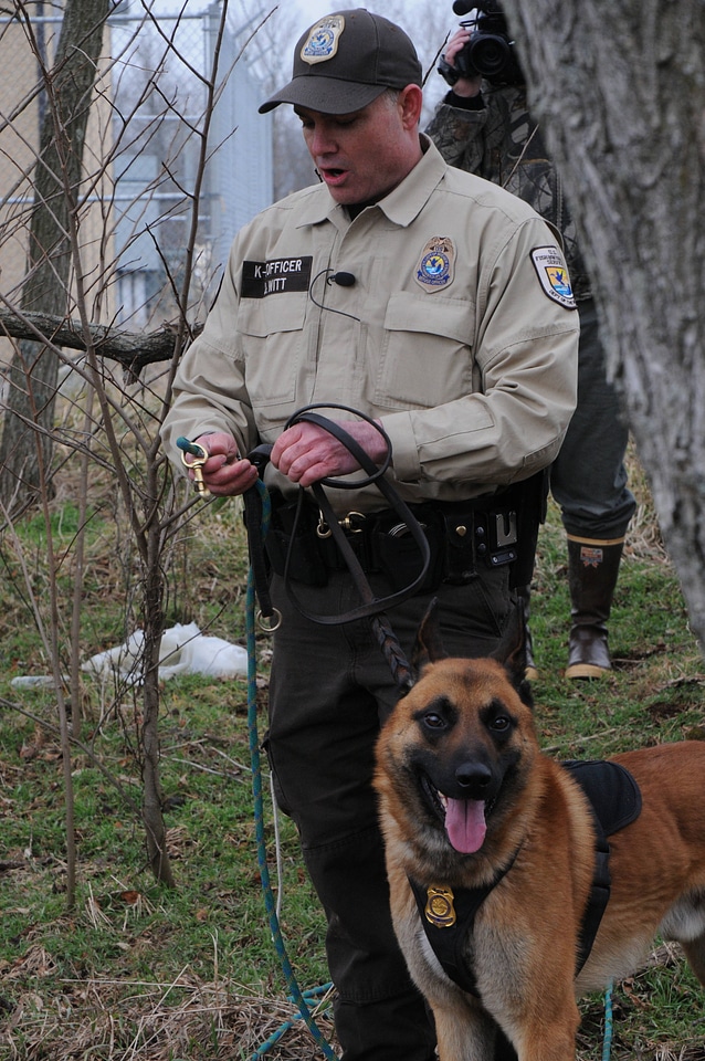 K-9 officer explaining about the different leashes and commands