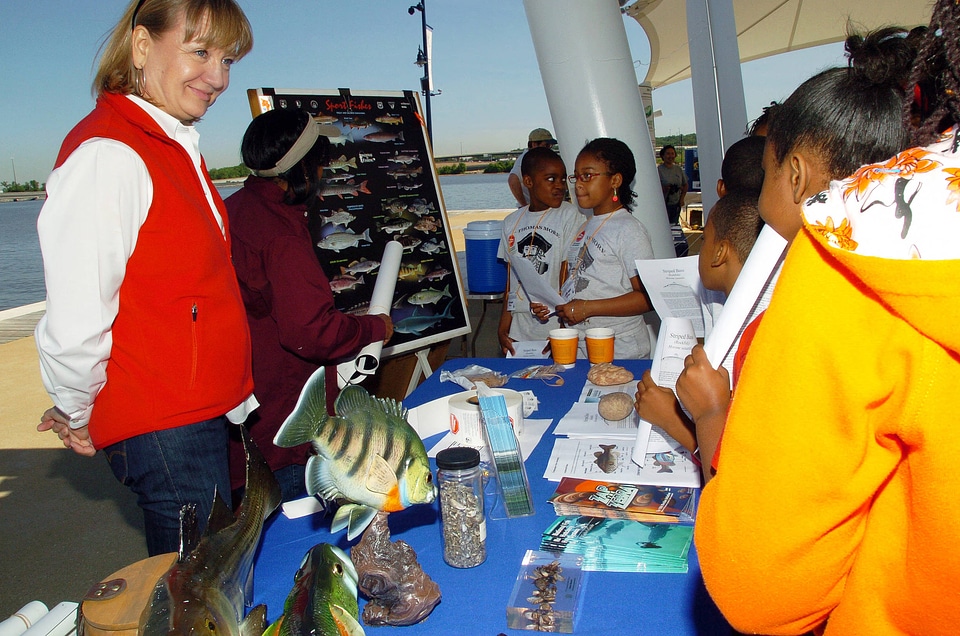 FWS employees teaching students about fishing