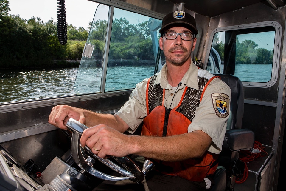 Fishery biologist pilots boat while collecting data on Asian carp-5