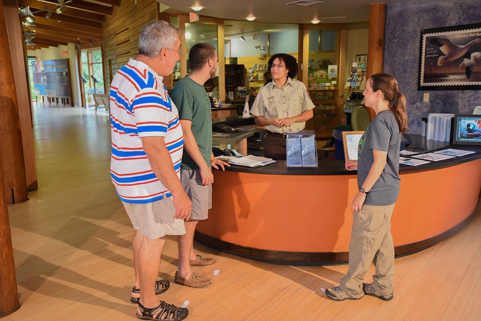 FWS Staff greets visitors at visitor center desk-2