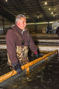 FWS employee prepares fish pump to load fish onto hatchery-5