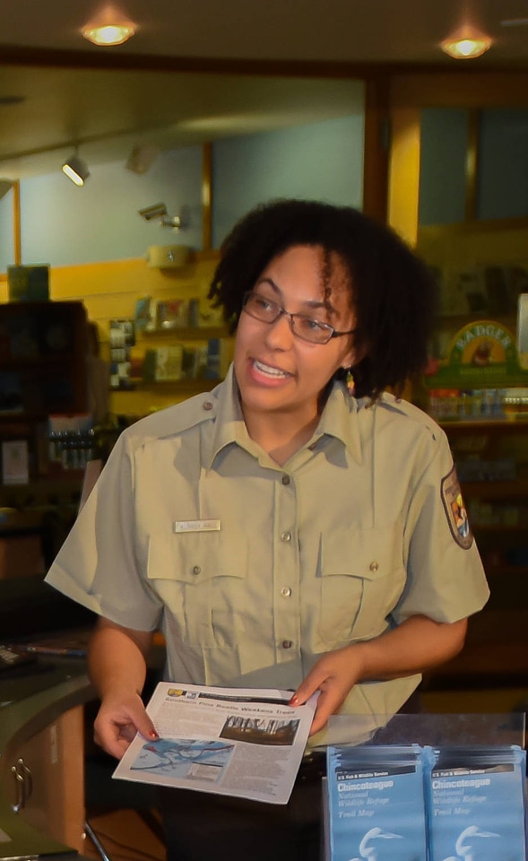 FWS Staff greets visitors at visitor center desk-2 photo