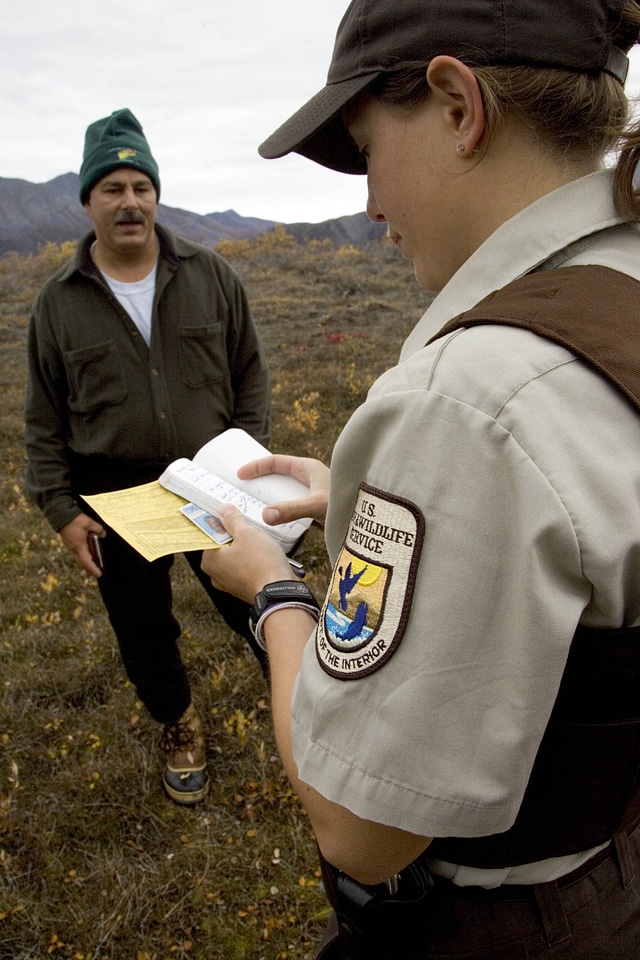 Refuge law enforcement officer verifying documents