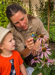 FWS employee with child and monarch