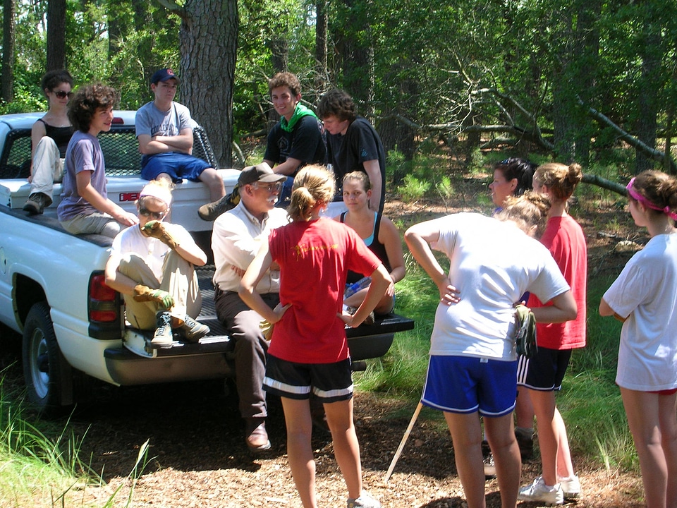 Service employee talking with a group of teen volunteers