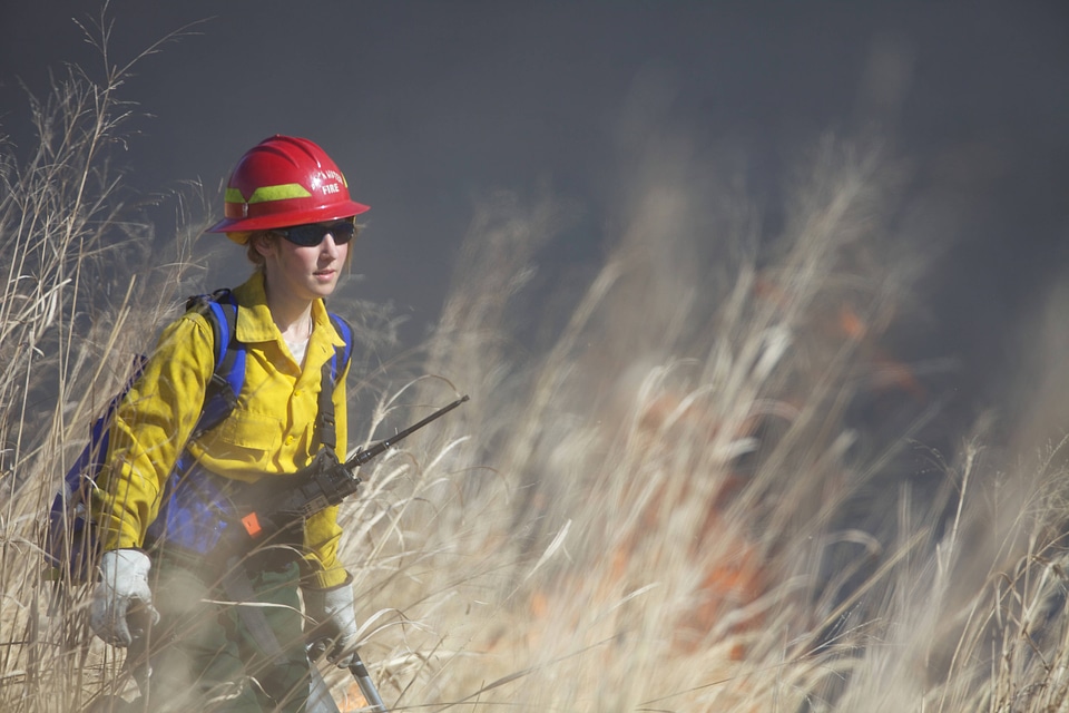Firefighter walking through field