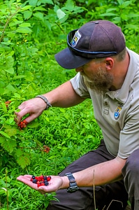 NCTC land management specialist with handful of wineberries and blackberries-4
