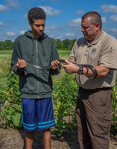 FWS Staffer shows young boy a Black Rat snake-3