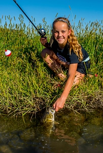 Girl catches smallmouth bass-1