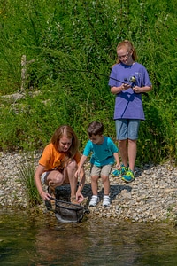 Family fishing, mother nets rainbow trout-14 photo