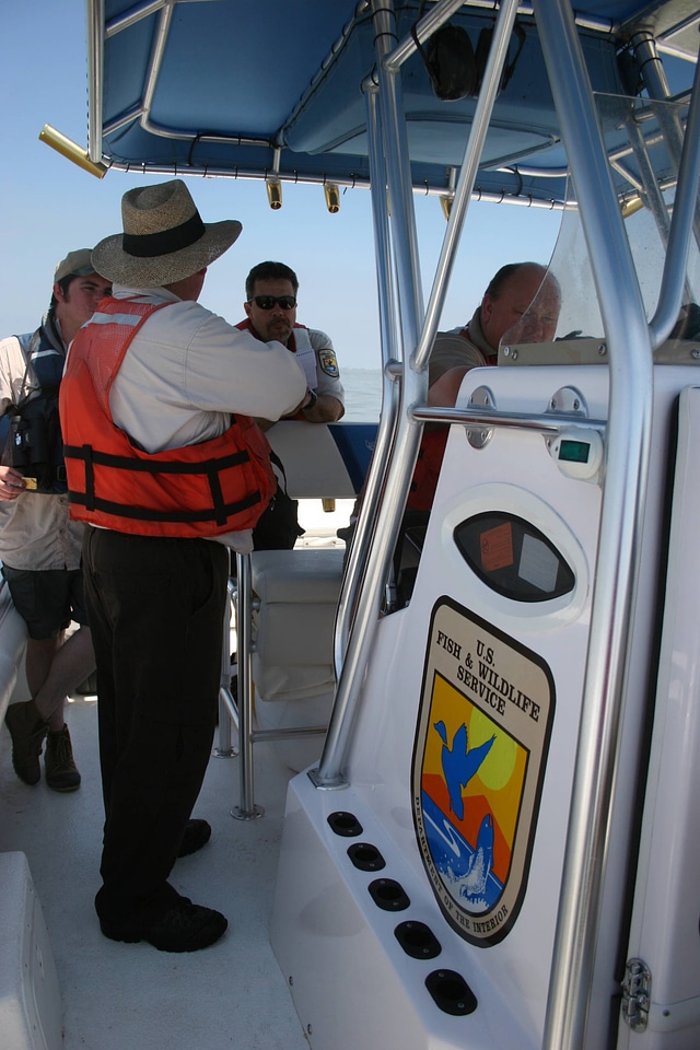 Service employees on a boat in the Gulf