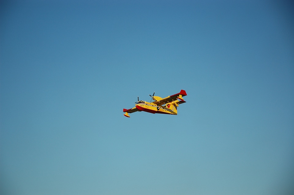 Fire fighting aircraft yellow flying