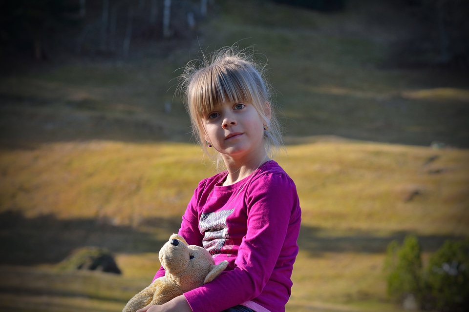 Girl teddy bear nature